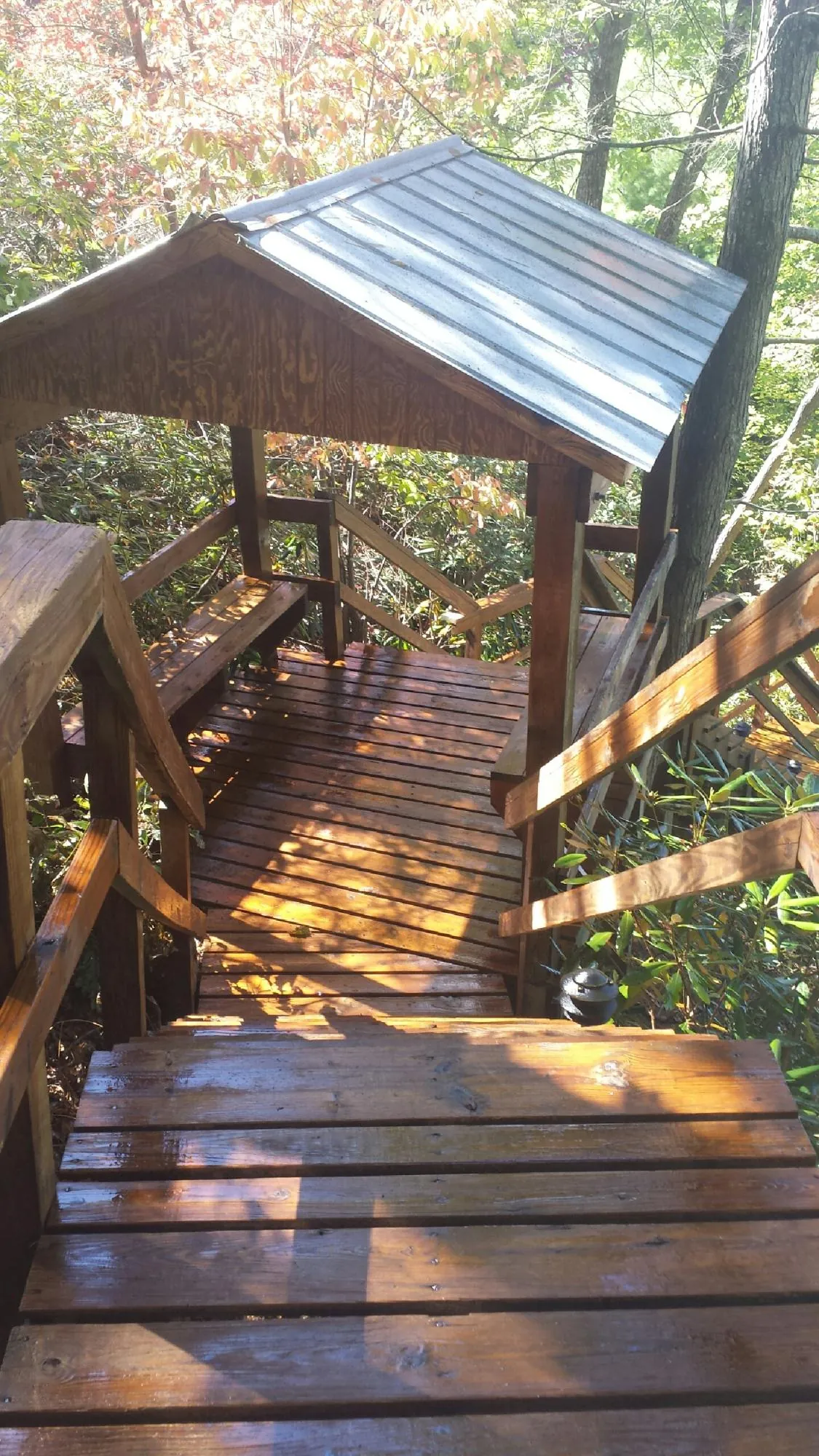 Freshly stained wood walkway and covered shelter with a metal roof in Harlowton